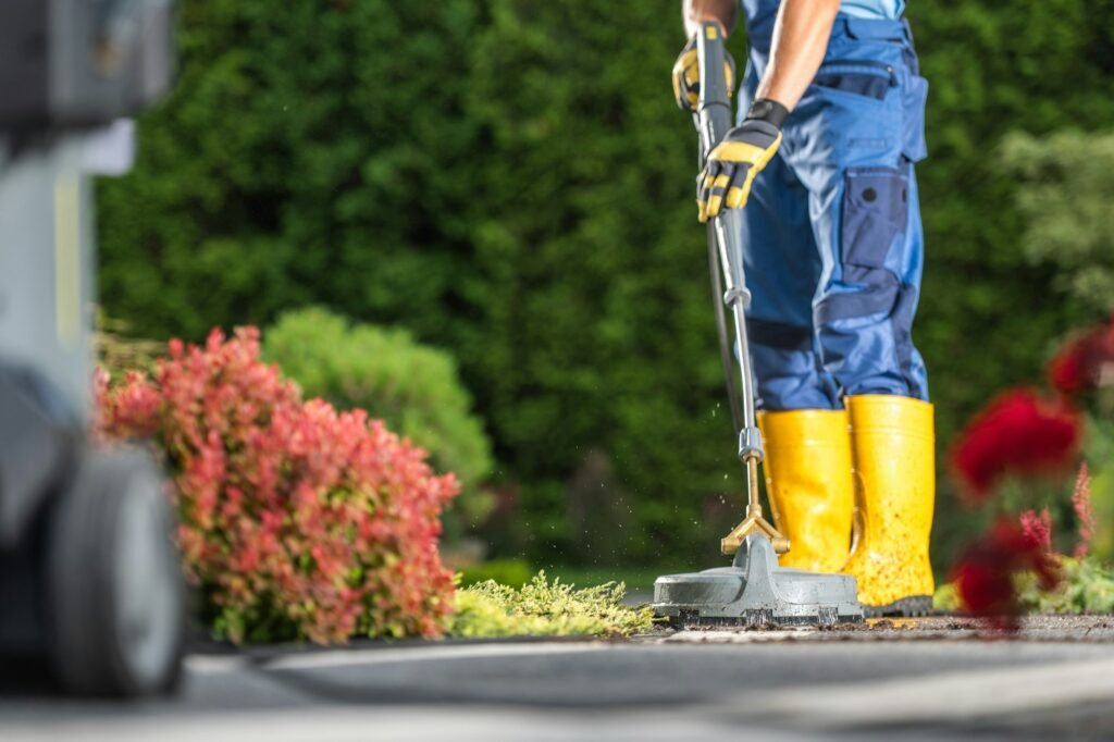 Man Pressure Washing Residential Driveway